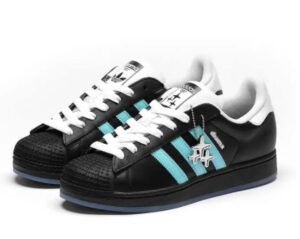 Drama Call x Adidas Superstar II limited edition shoe, showcasing a stylish aqua blue colorway inspired by Manchester's Metrolink network