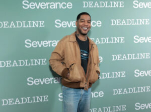 “Kid Cudi’s auctioned items on display, including gold chains, designer sneakers, and vintage music T-shirts.”