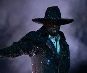 Usher performing in custom Robert Wun x Swarovski crystal-embellished outfit on stage in London, opening night