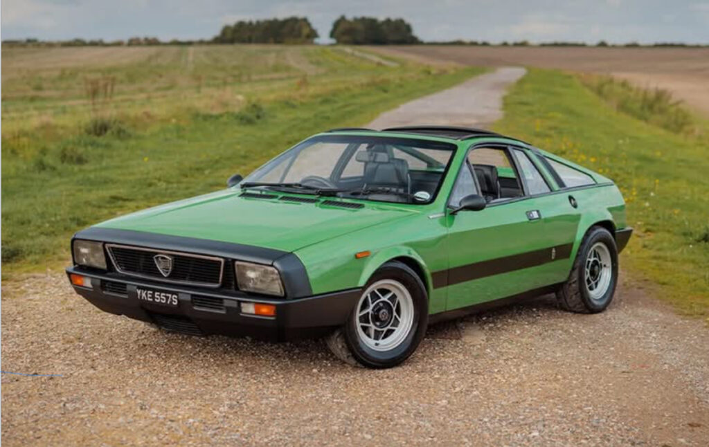 Side view of the 1975 Lancia Montecarlo (Scorpion) in red, showcasing its mid-engine proportions and Pininfarina design