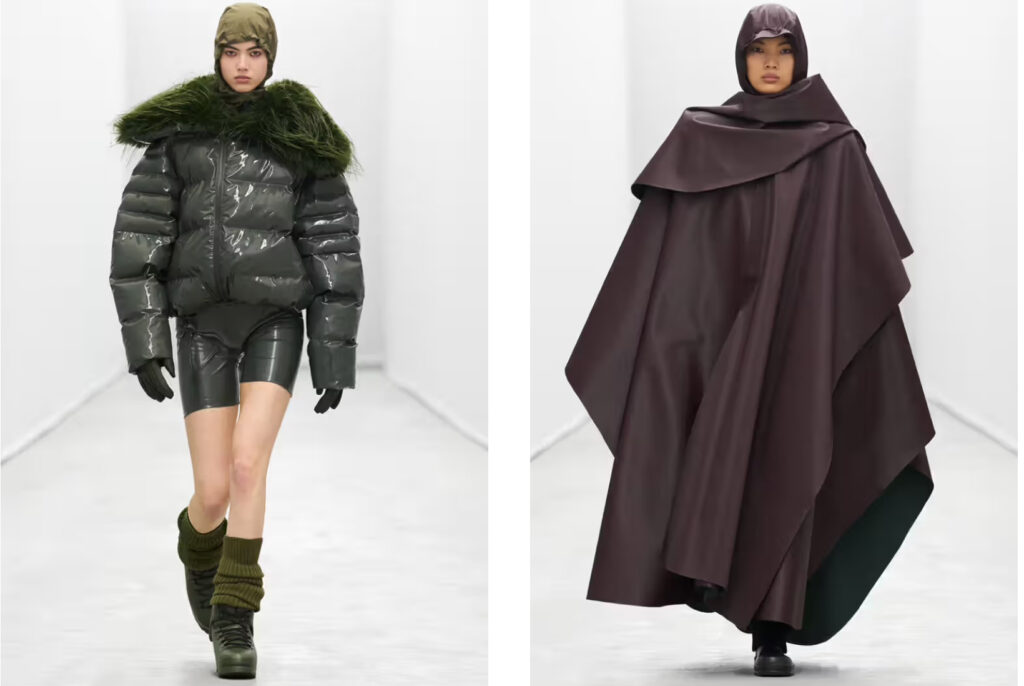 Model walking in Rains FW25 runway show wearing waterproof outerwear with technical textures inside Aarhus headquarters