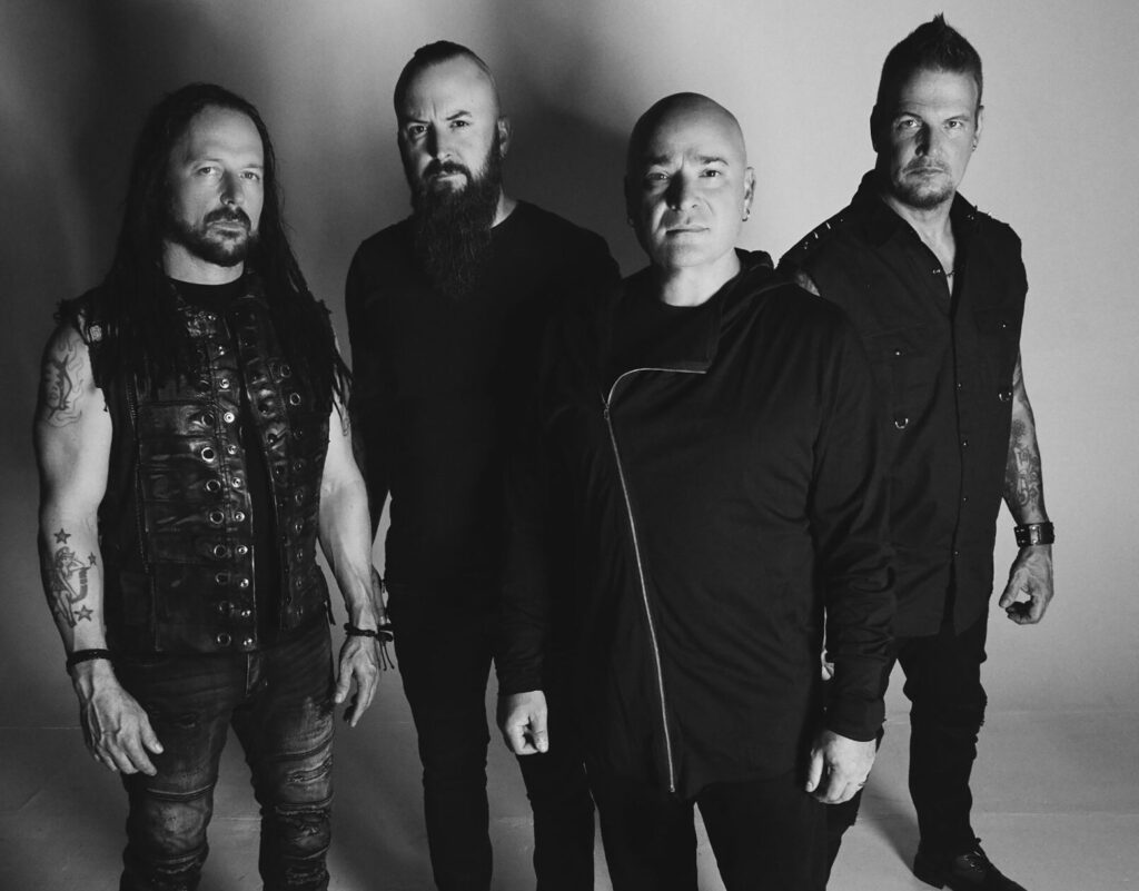 Disturbed performing “The Animal” live, with dark stage lighting echoing the song’s intense, primal themes
