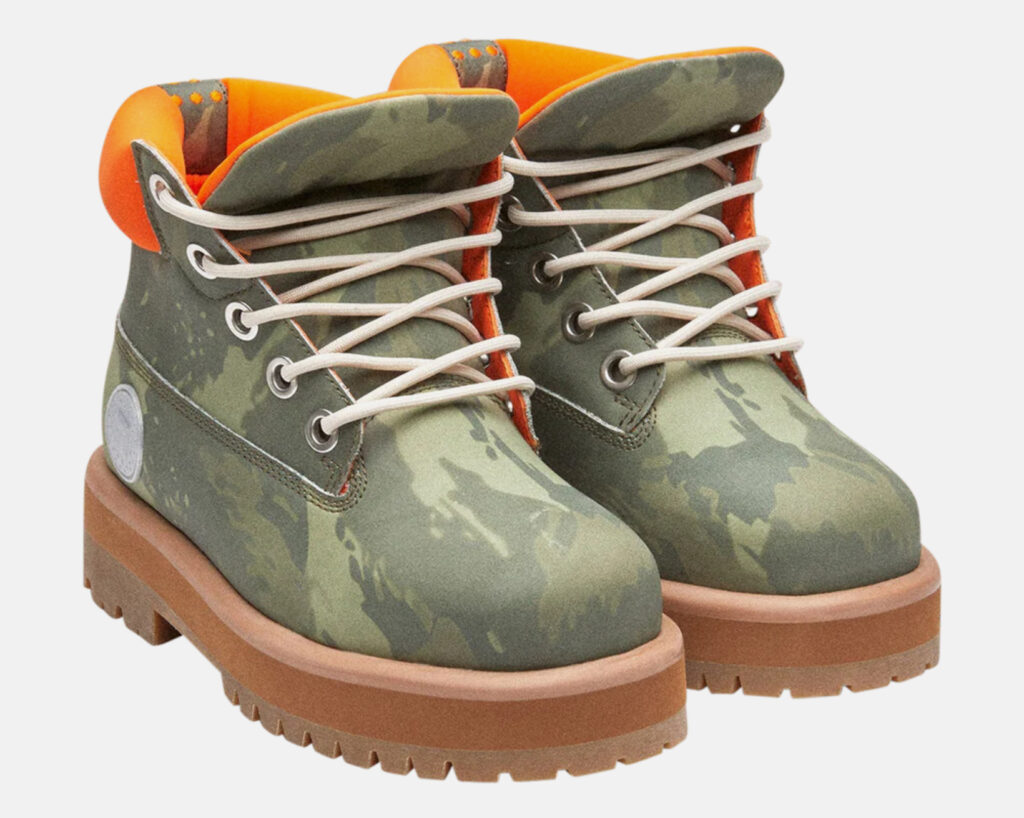 Model wearing PDF CHANNEL STRADA Green Camo jacket and cargo pants in muted forest tones, standing in an urban underpass