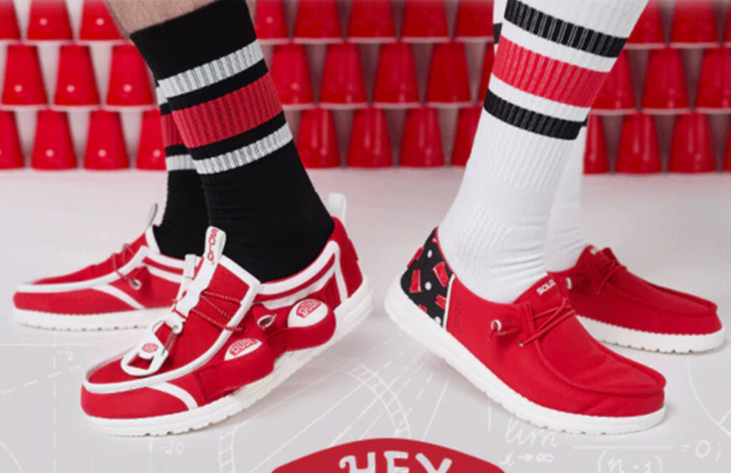 Hey Dude x Solo Cup red slip-on shoes featuring Solo-inspired ribbed design and white soles, perfect for summer parties