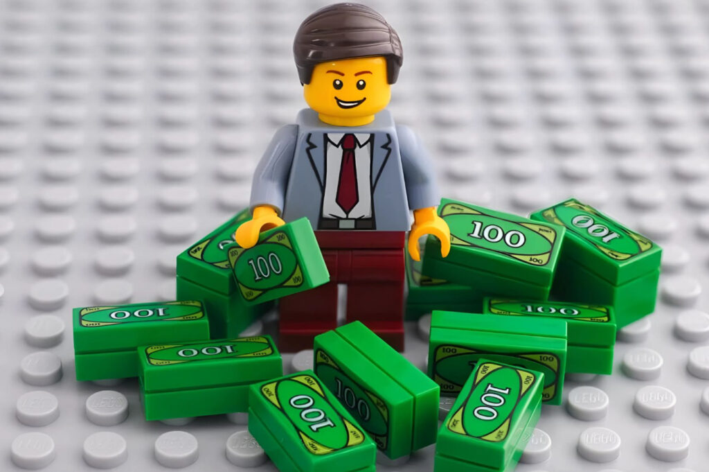 LEGO bricks arranged into a rising bar graph with a red Formula 1 car in the foreground