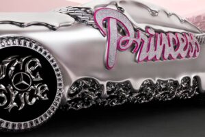 Ice Spice poses beside her custom molten chrome Mercedes-Benz CLA, adorned with pink interiors and sculptural details