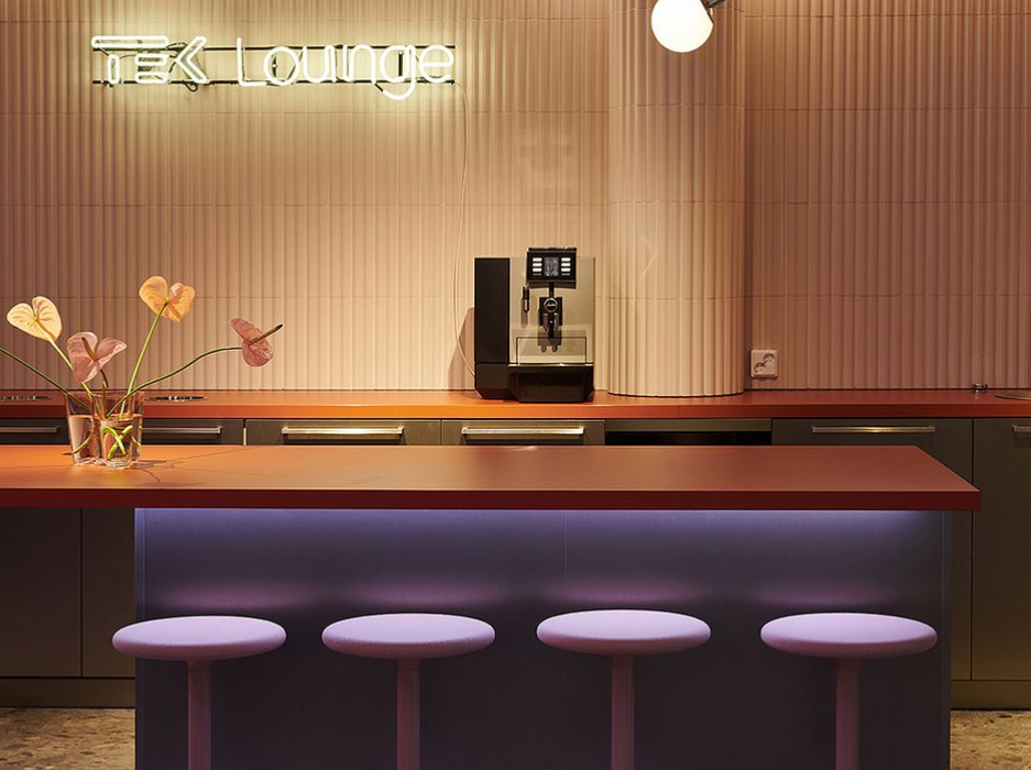 Interior of TEK Lounge at Tampere University featuring modern Scandinavian furniture, wood textures, and student seating