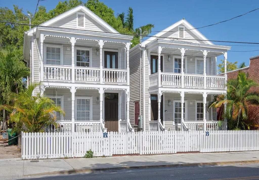 View of two updated Key West homes at 421–423 Simonton Street, each with private pools and tropical landscaping