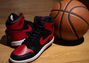 Close-up of the Air Jordan 1 Hi ’85 “Bred” sneaker showing black and red leather upper, white midsole, and classic high-cut profile
