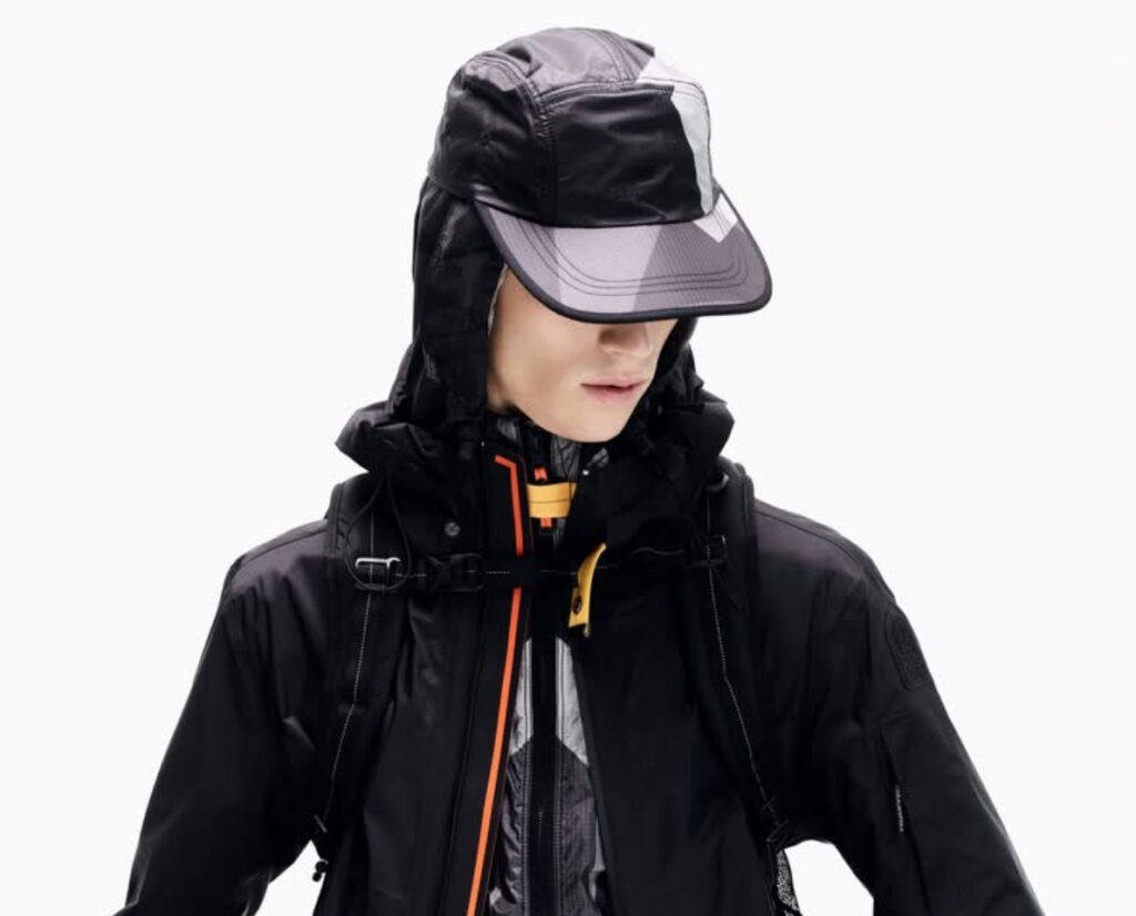 Parajumpers Aso Waterproof Jacket in black, featuring a hood, front zipper, and signature yellow strap
