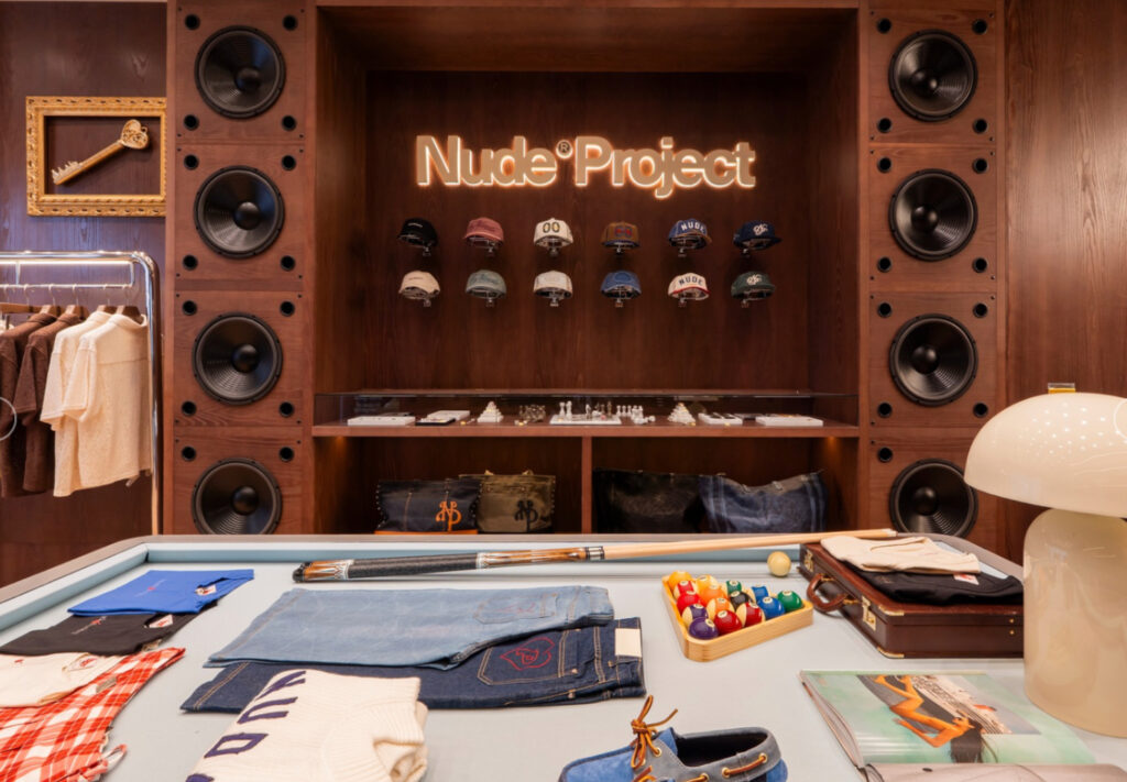 Interior of Nude Project’s Amsterdam store featuring Kubrick-inspired design elements and minimalist streetwear displays