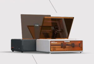 “Creality Falcon A1 desktop laser cutter in use, engraving wood inside an enclosed work area with built-in filtration.”