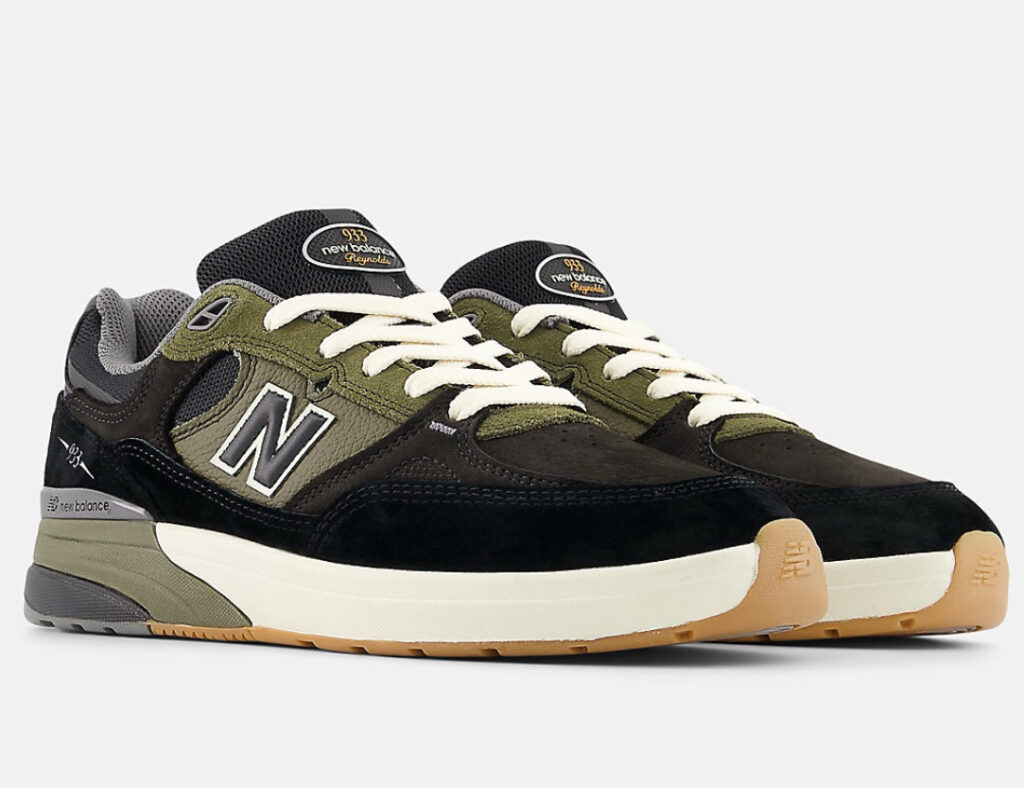 Numeric Andrew Reynolds 933 skate shoe in black suede with vulcanized sole, photographed on a concrete skate surface