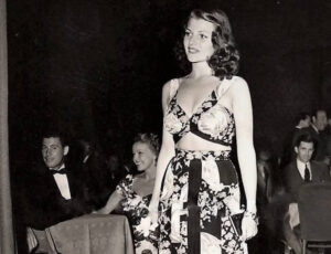 Rita Hayworth seated at a 1940s nightclub, elegantly dressed, surrounded by vintage décor and Hollywood atmosphere