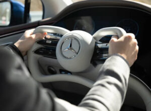 Mercedes-Benz yoke steering wheel featured in the 2025 AMG EQE, showcasing futuristic design and steer-by-wire technology