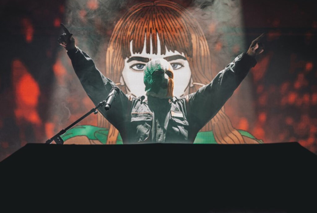 Kneecap performing politically charged set at Coachella 2025, defiant energy under festival stage lights