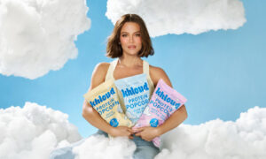 Khloud Protein Popcorn bags in pastel packaging featuring White Cheddar, Olive Oil and Sea Salt, and Sweet and Salty flavors