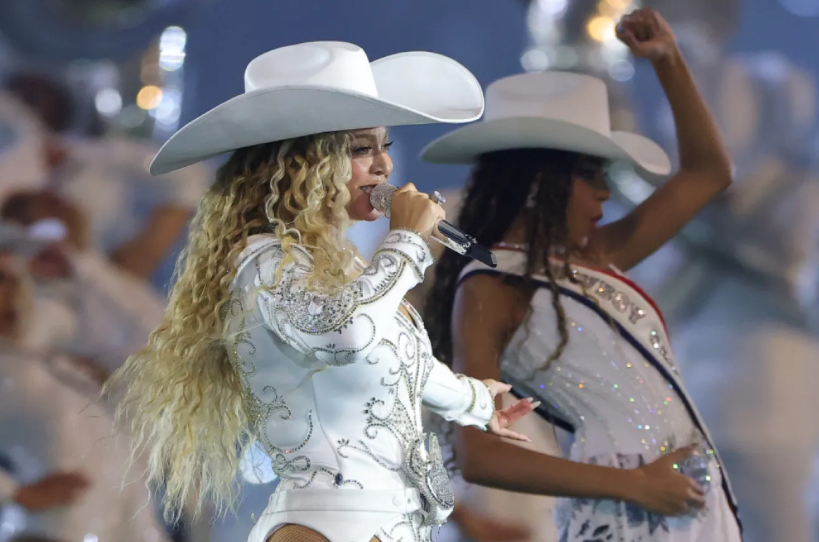 Beyoncé performing onstage during Cowboy Carter Tour opening night at SoFi Stadium, dressed in Western-inspired leather attire