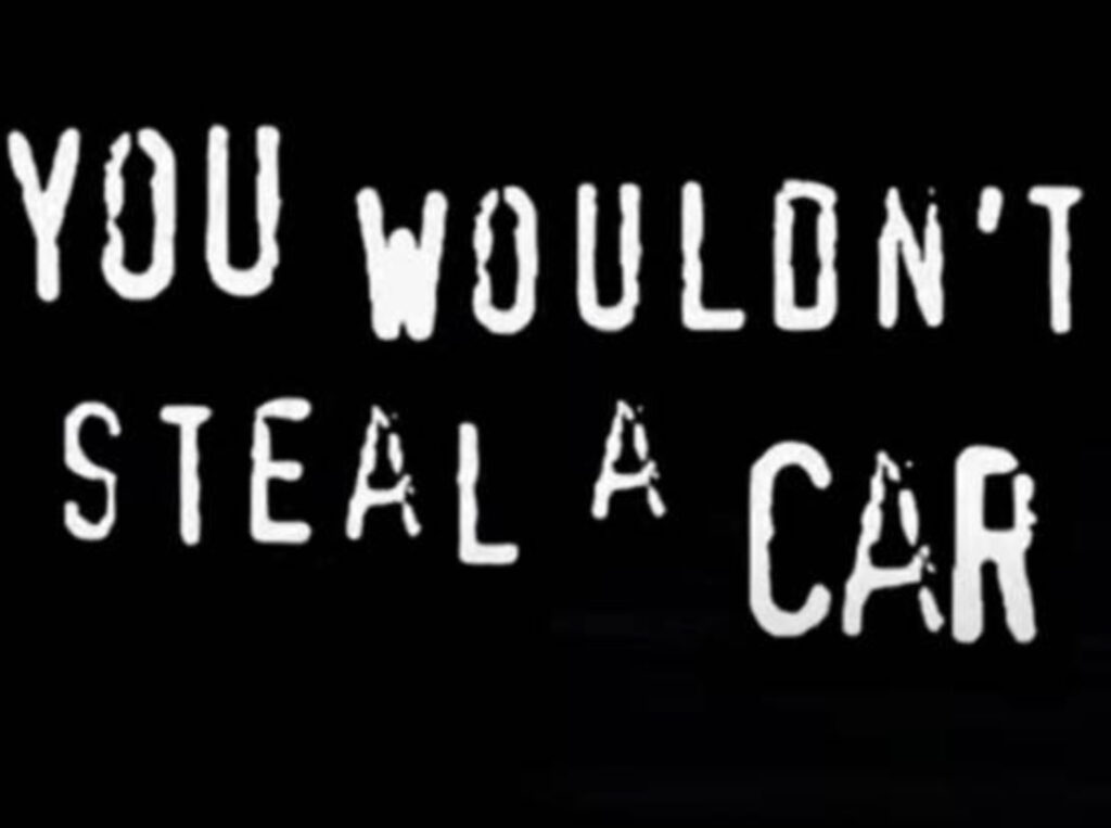 Screenshot of the “You Wouldn’t Steal a Car” anti-piracy PSA with bold text in a noir-style font resembling FF Confidential