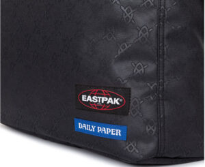 Daily Paper x Eastpak backpack featuring logo and beaded zipper pullers, styled on K.O. Asante in a colorful home set