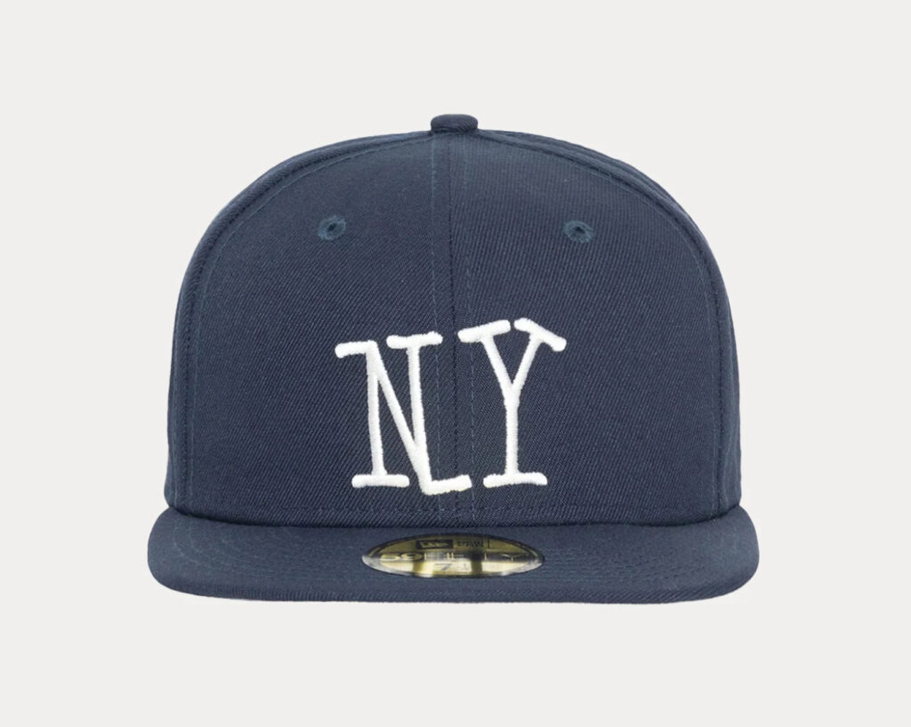 Stüssy x New Era 59FIFTY fitted cap with embroidered logo on front and side, flat brim, black polyester design