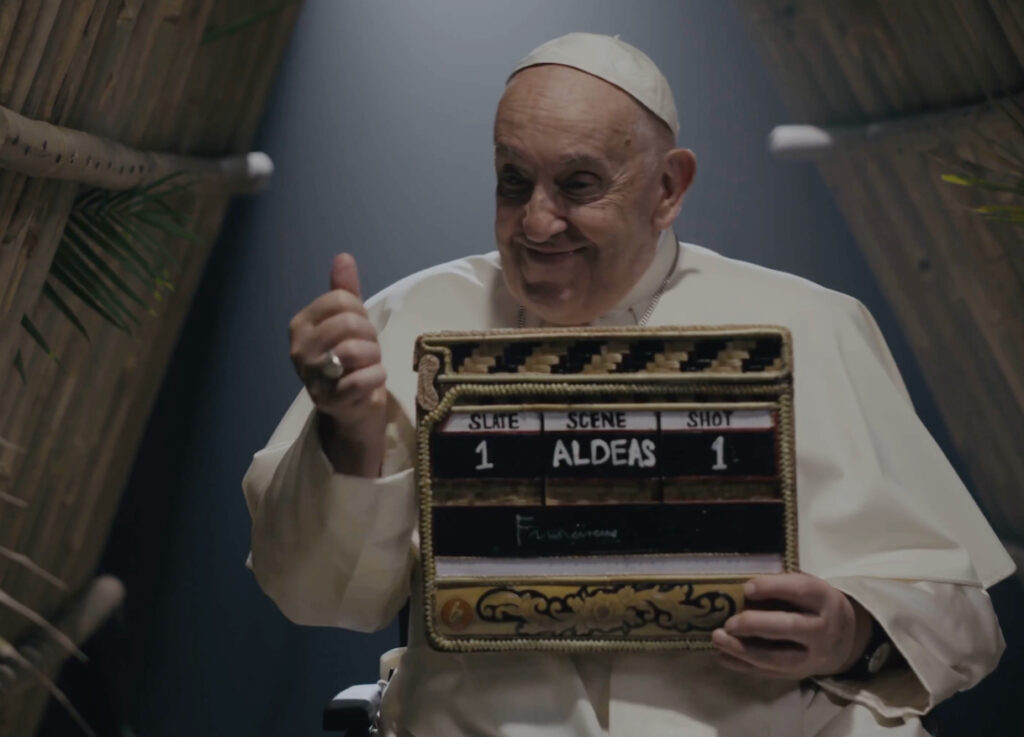 Pope Francis seated in conversation, softly lit, symbolizing reflection and spiritual dialogue