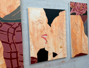 Portrait of Isaac Andrews in his East London studio, surrounded by in-progress canvases and oil paints