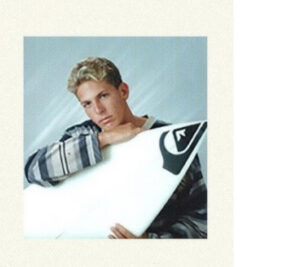 Young Andy Irons surfing a Hawaiian break, capturing the raw energy and fearless style of his early surf career