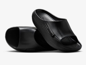 A pair of Nike ReactX Rejunve8 Sandals featuring sculpted midsoles and breathable uppers designed for recovery and comfort