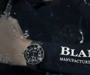 Blancpain Fifty Fathoms Ocean Commitment watch resting on coral reef, symbolizing marine conservation and horological legacy