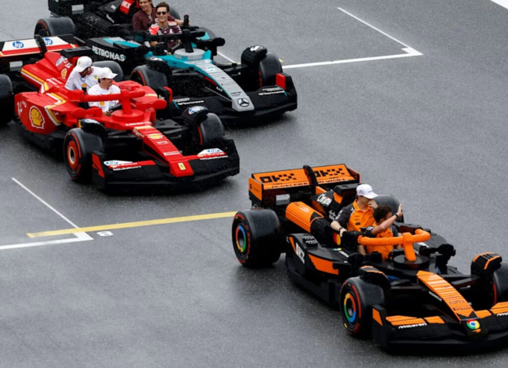 Formula 1 drivers riding in life-sized, fully functional LEGO F1 car replicas during the 2025 Miami Grand Prix parade