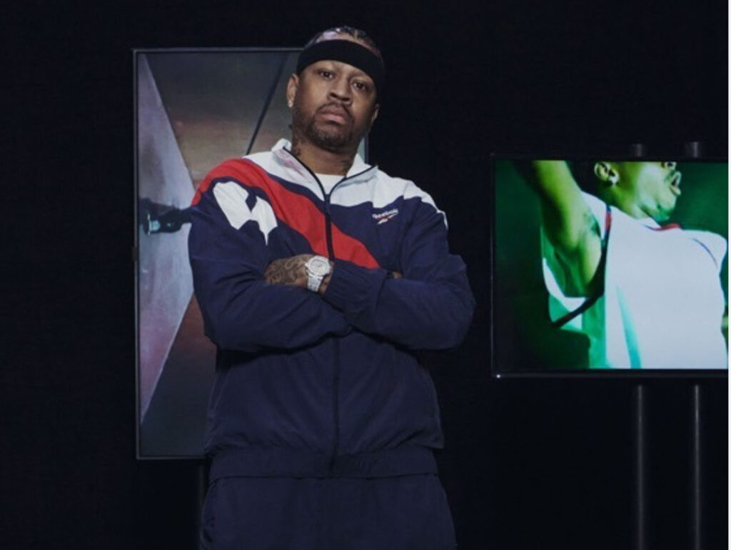 Jide Osifeso standing in Reebok studio surrounded by mood boards and sneakers, signaling new basketball vision for the brand