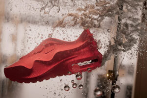 Side profile of the Nike Air Max 1000 shoe, showcasing its 3D-printed structure and streamlined futuristic silhouette.