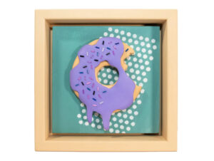 Vibrant 3D donut wall art by Victo featuring purple glaze, rainbow sprinkles, and pop art lettering in a playful frame