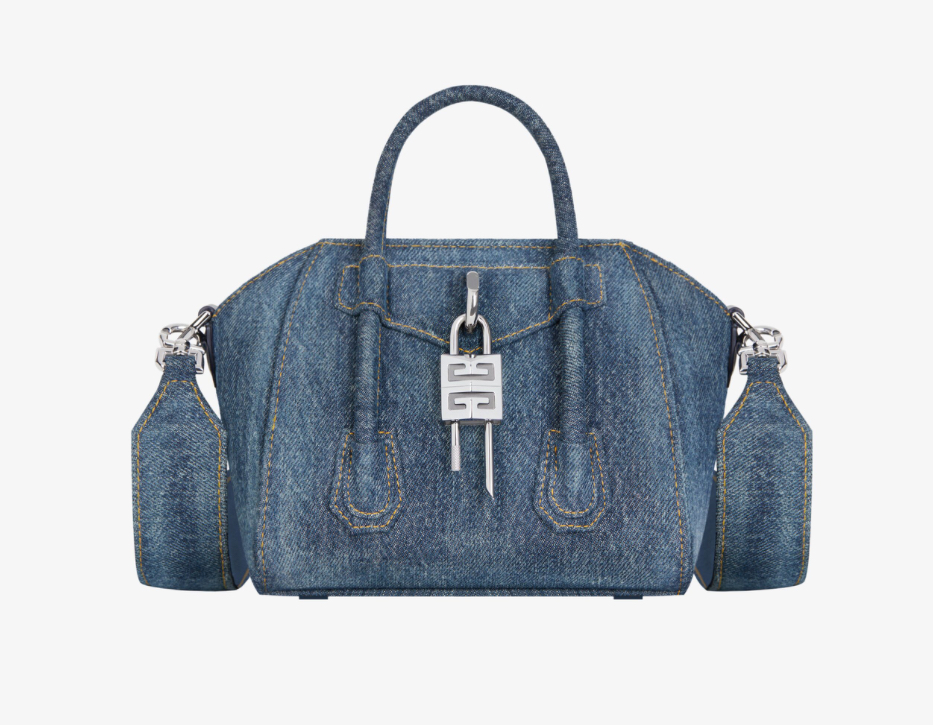Close-up of Givenchy’s Antigona Toy Lock bag in dark blue washed denim with silver-tone lock and structured mini silhouette