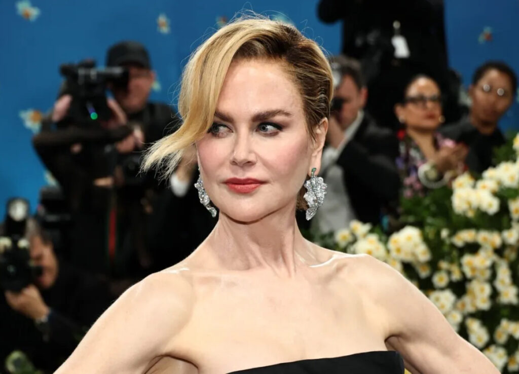 Nicole Kidman at the 2025 Met Gala with a pixie haircut, tailored black gown, and soft nude lips using Westman Atelier makeup