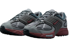 Side profile of the Nike Pegasus Wave running shoe in Cool Grey and Dark Team Red colorway with mesh upper and sculpted midsole