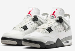 Side view of Nike Air Jordan 4 “White Cement” shoes showcasing white leather upper, speckled midsole, and heel tab branding