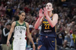 Caitlin Clark dribbling past defenders during a WNBA game, showcasing her scoring and playmaking dominance