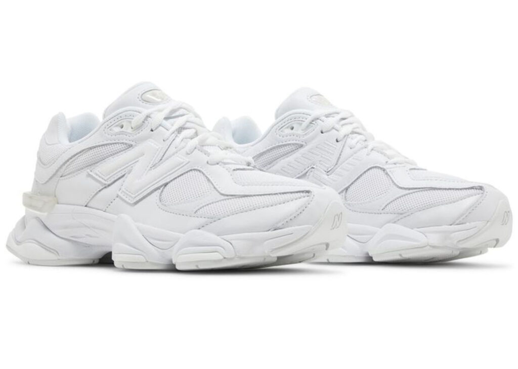 Side view of the New Balance 9060 Triple White shoe showing mesh and suede construction with a chunky sole