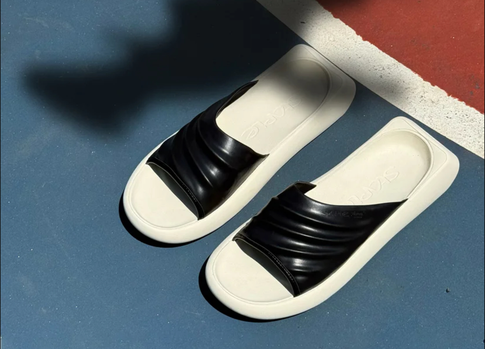 The STAPLE x VIBRAM KIMSET Slide in a side profile, showcasing its minimalist upper and performance-driven sole