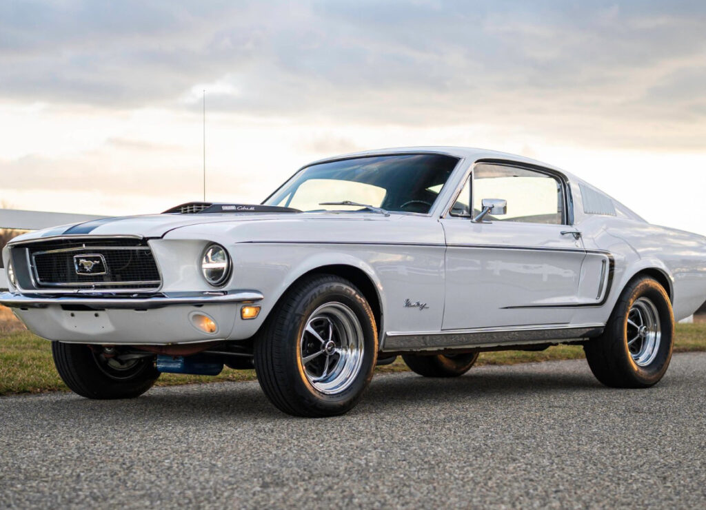 Restored 1968 Ford Mustang Fastback with 428 Cobra Jet engine featuring modern suspension and vintage bodywork