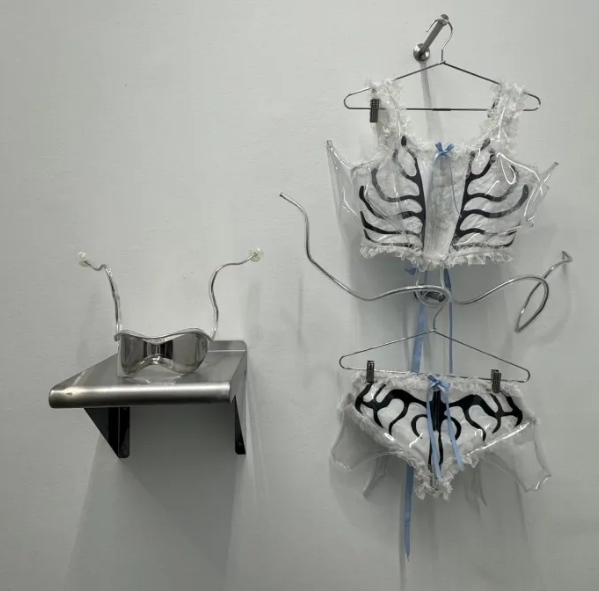 Lizzy Choi’s Ctenophora (2025) sculptural corset, briefs, and antenna sunglasses displayed against a gallery wall