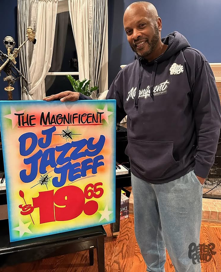 DJ Jazzy Jeff smiles beside colorful Peter Paid artwork reading “The Magnificent DJ Jazzy Jeff $19.65” in retro style