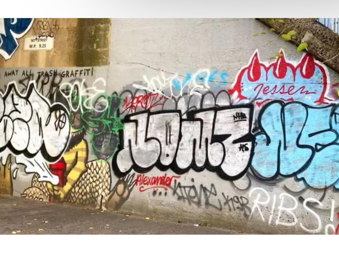 Rooftop graffiti piece in The Bronx, captured at dawn with bold wildstyle letters on a brick wall