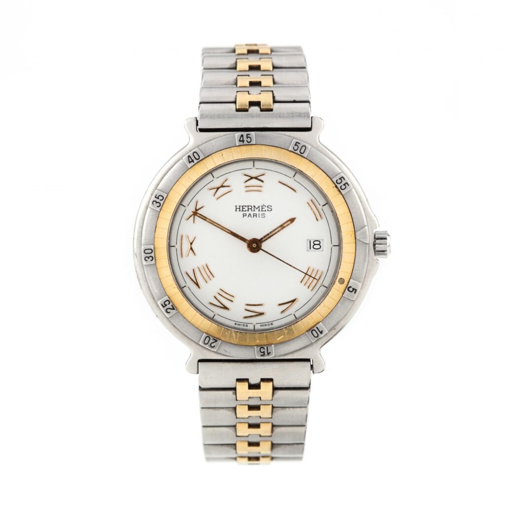 Close-up of Hermès Captain Nemo ladies watch with gold and steel bracelet, Roman numeral dial, and unidirectional bezel