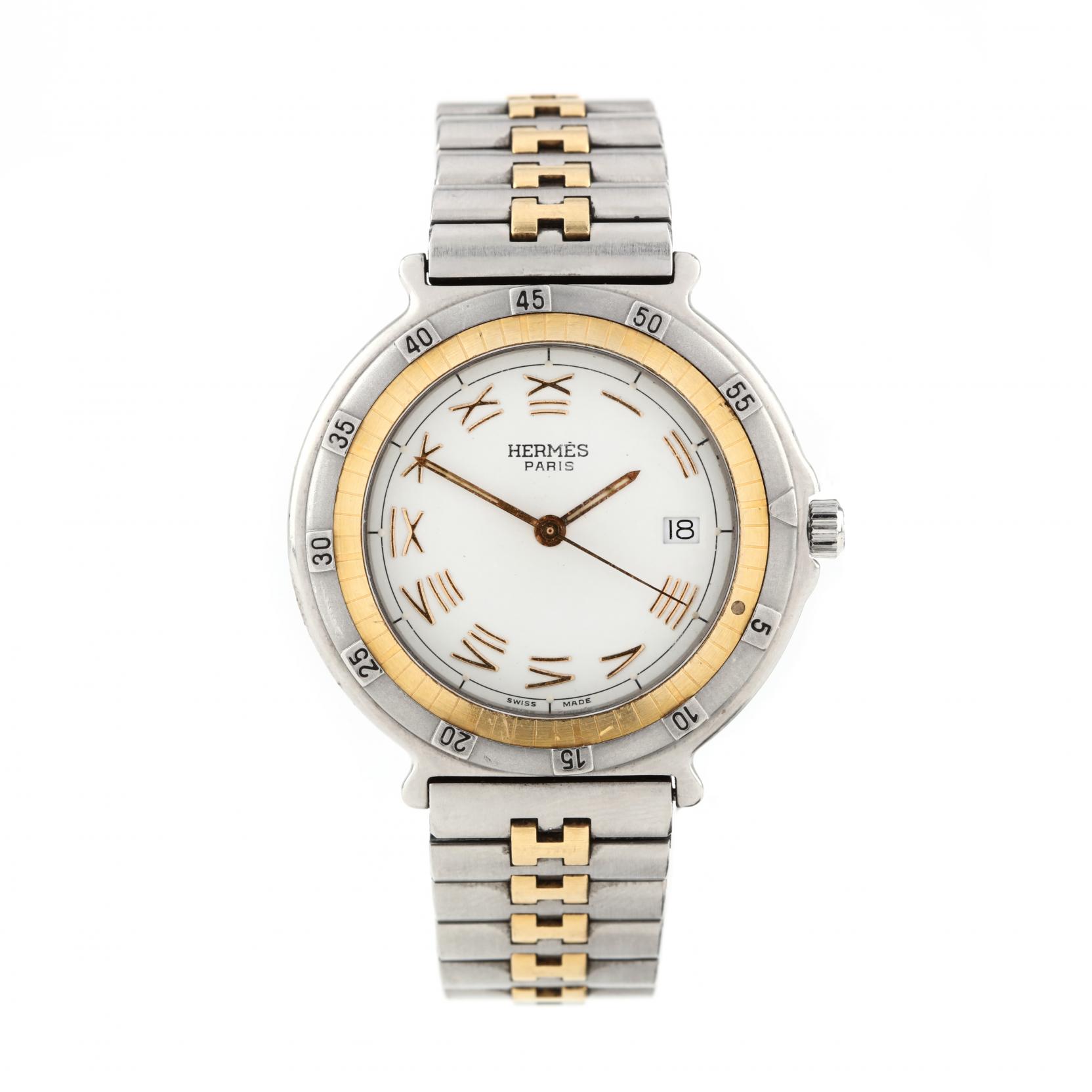Close-up of Hermès Captain Nemo ladies watch with gold and steel bracelet, Roman numeral dial, and unidirectional bezel