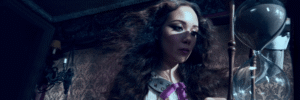 Laufey performing live in a vintage-style gown, illuminated on stage, singing “Lover Girl”