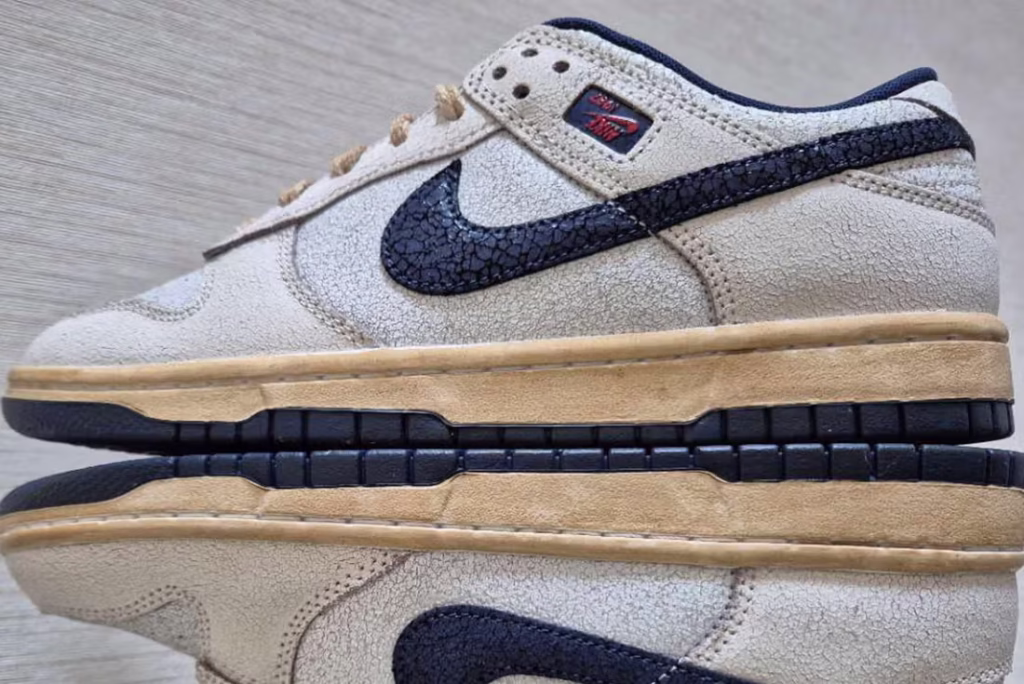 Nike x Stranger Things Dunk sneaker featuring cracked white leather, upside-down Swooshes, and 1980s-inspired worn detailing