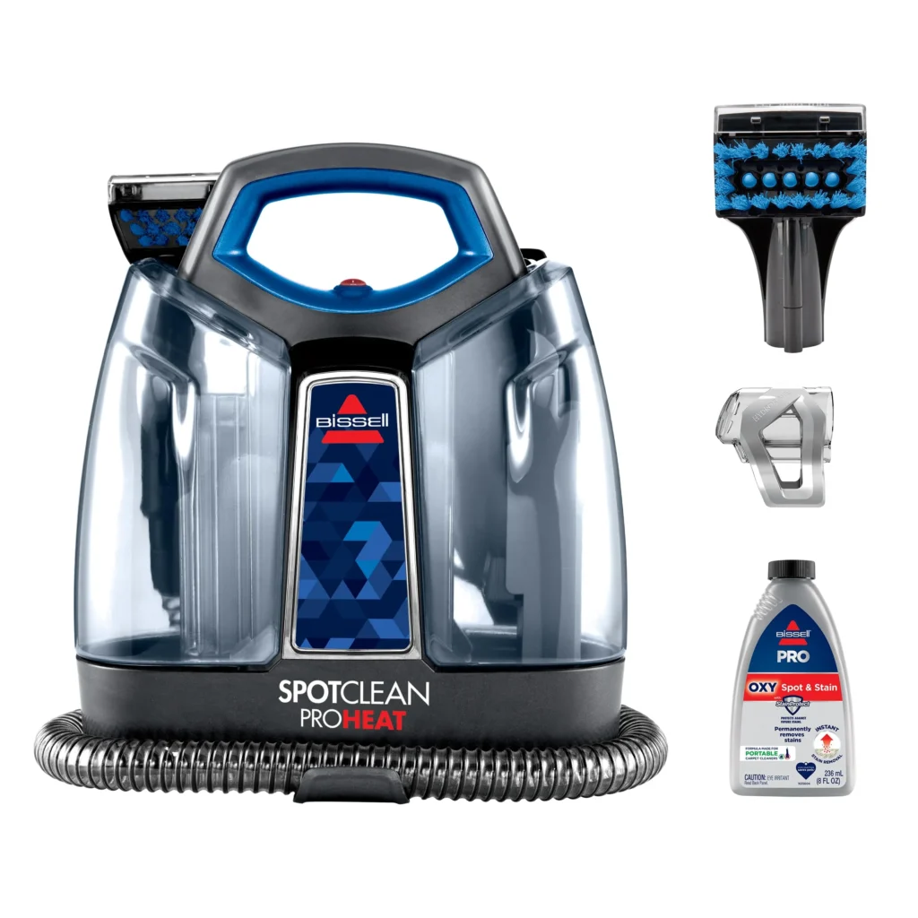 Bissell SpotClean ProHeat 2694 in blue, with hose and stain tool attached, displayed on a carpeted floor ready for use
